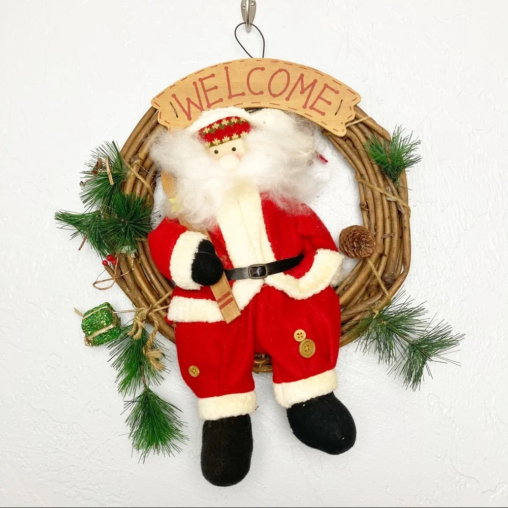 Christmas wreath with stuffed Santa Claus
